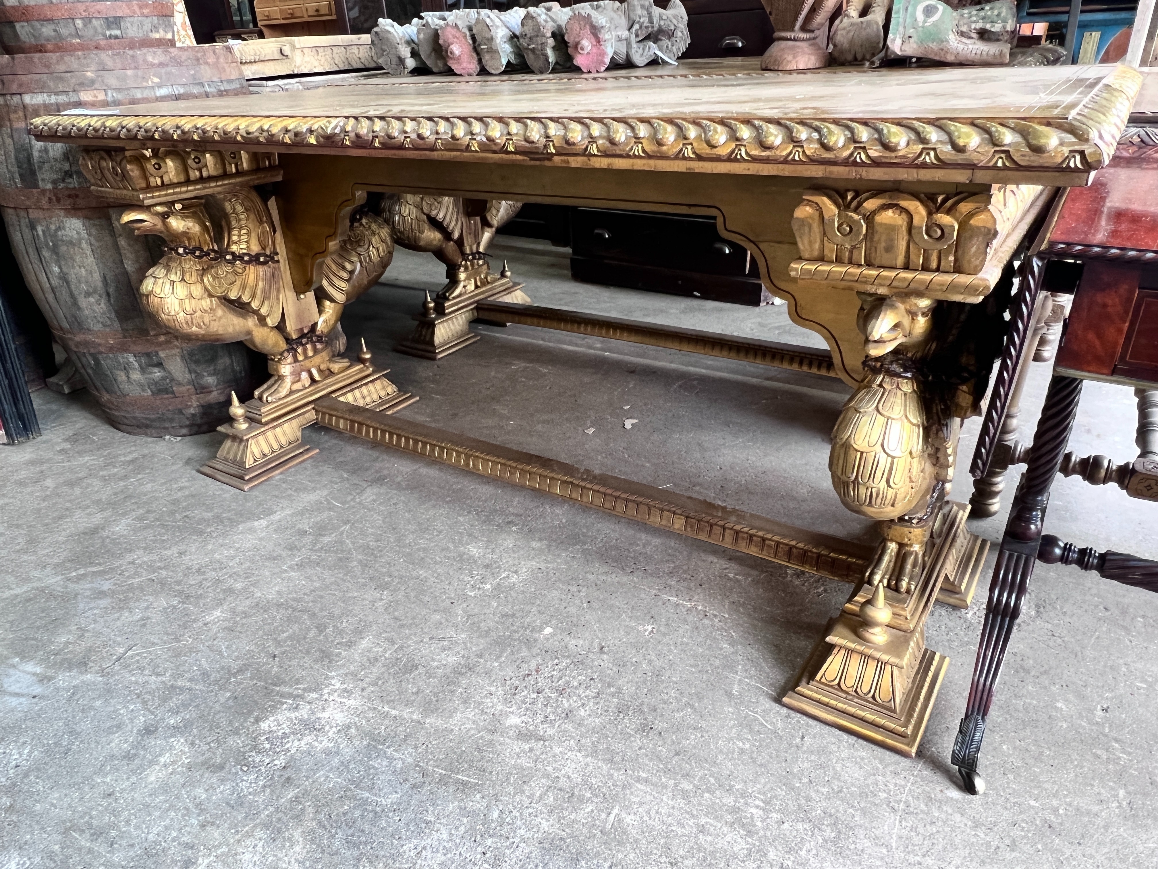 A pair of Renaissance style rectangular giltwood and composition centre tables, on chained eagle supports, width 184cm, depth 82cm, height 86cm